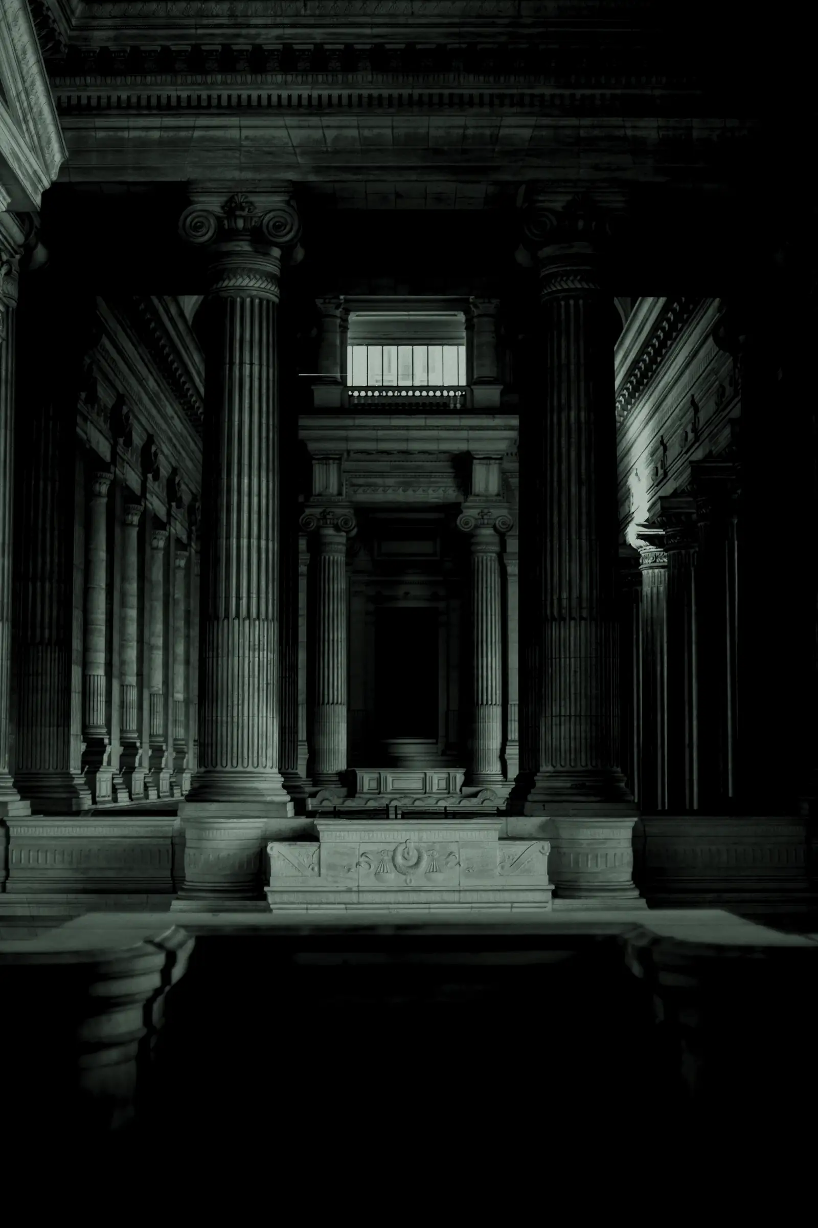 Stone columns in the hall of a neoclassical palace of justice