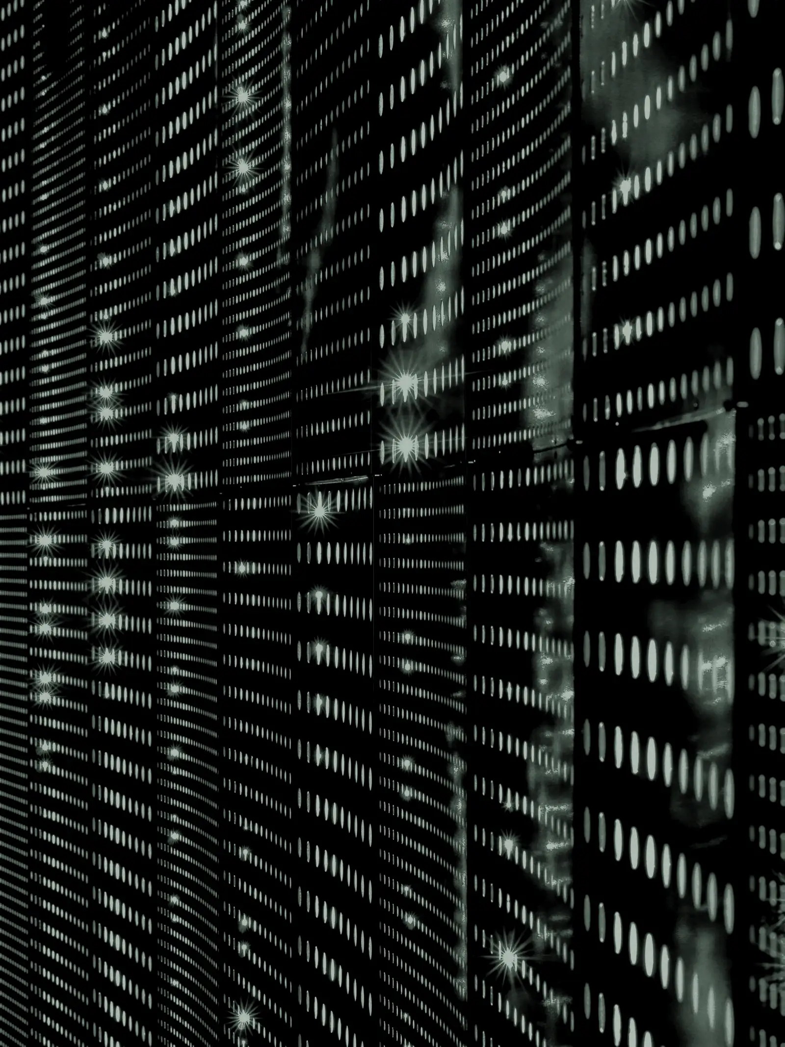 Rows of server racks lit by blue indicator lights in a data centre