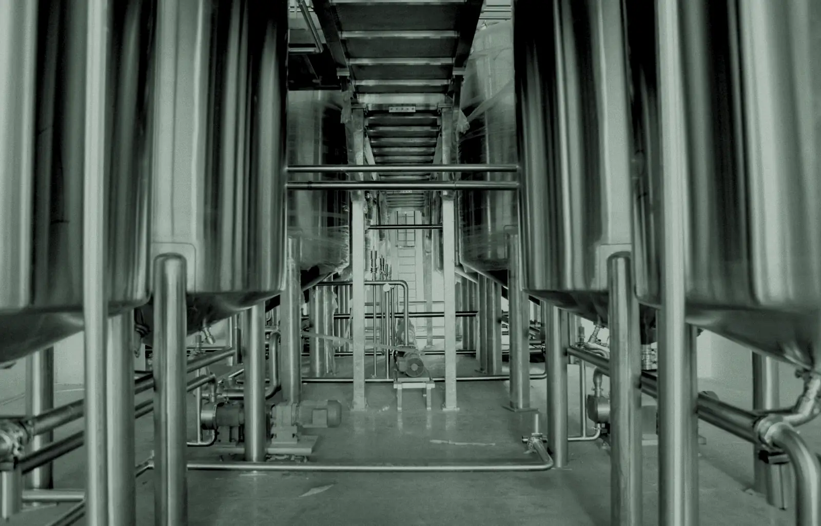 Corridor of stainless steel process tanks in an industrial plant
